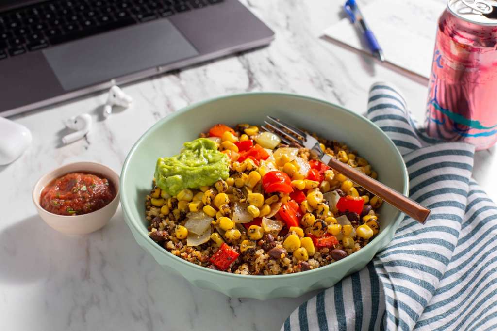 https://media.sunbasket.com/2022/02/Tex-Mex-Black-Bean-Quinoa-Bowl-on-Desk-next-to-Laptop_3_4-View_2x3H_Web-1024x683.jpg