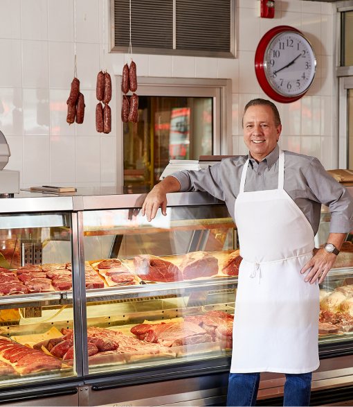 Ray Rastelli standing in front of a butcher counter