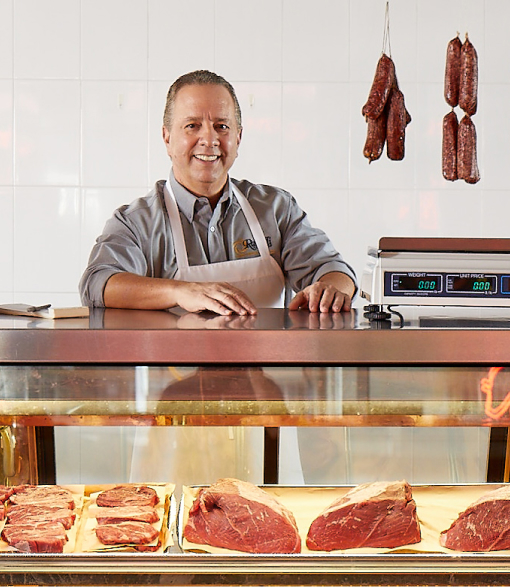 Ray Rastelli behind a butcher counter