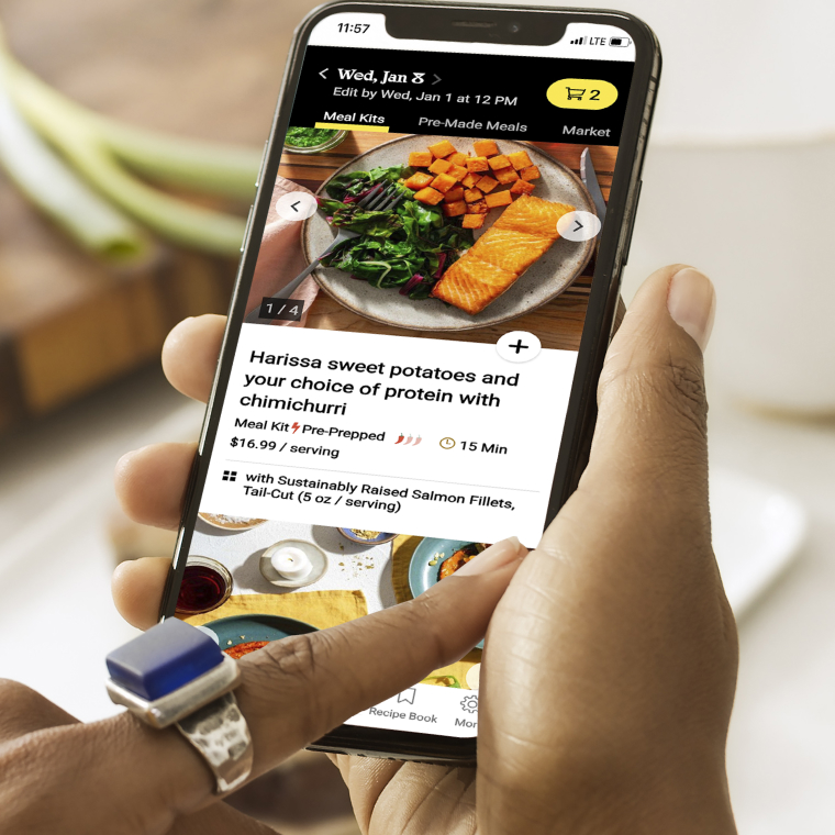 Phone with person choosing meals.